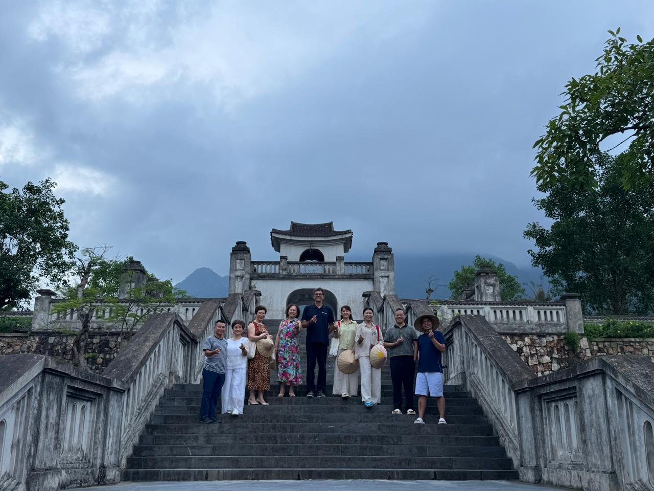 Guests walking together through the Yên Tử mountain setting at the end of An Retreat