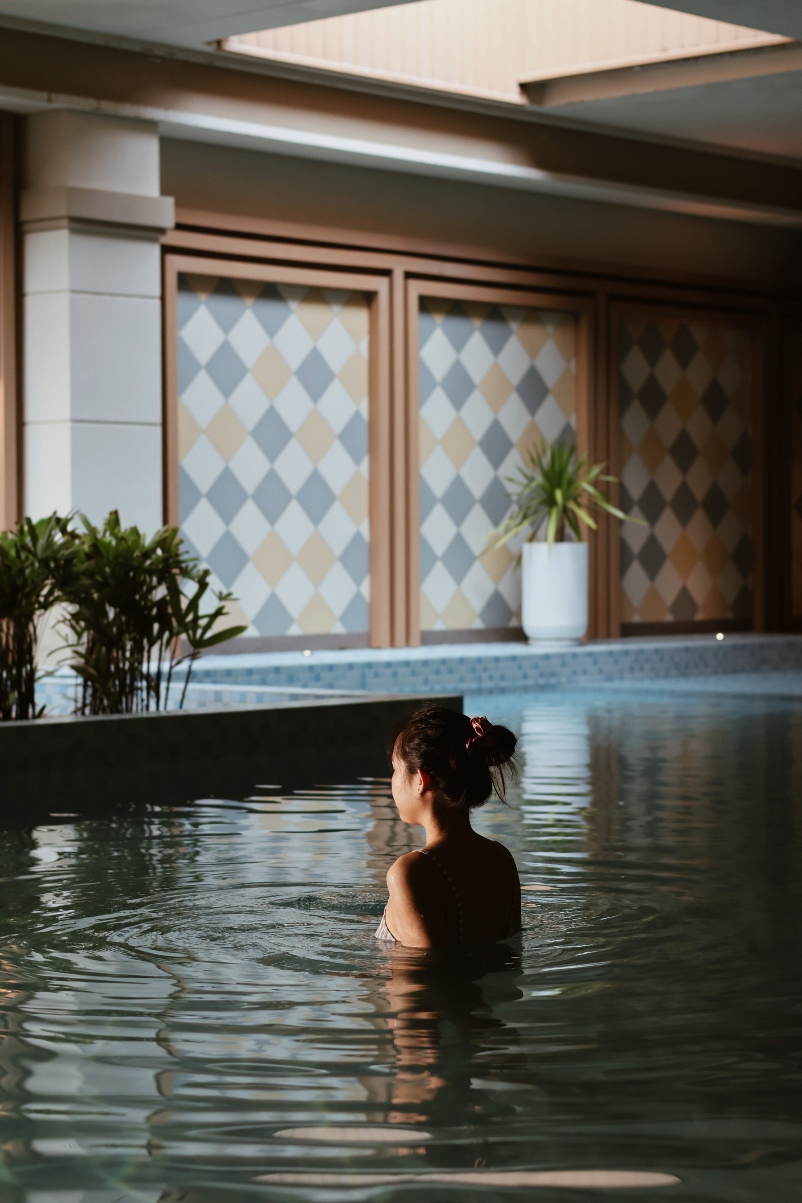 A guest resting in the wellness pool at Fusion Resort Da Nang