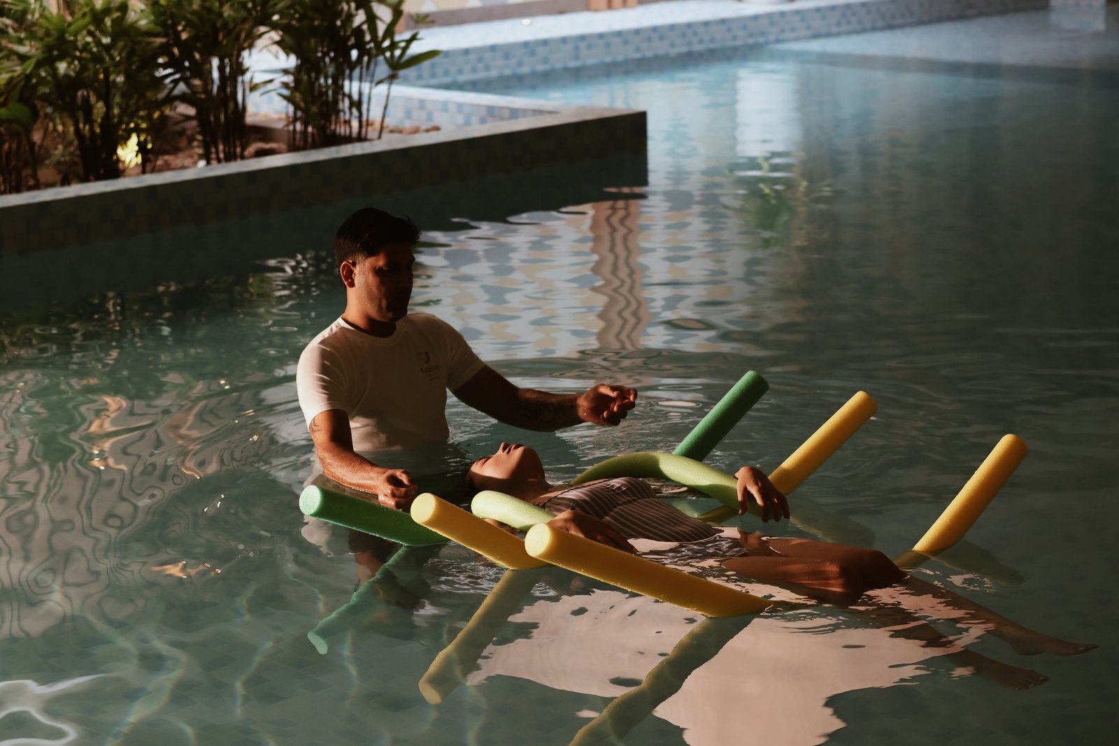 A guest receiving sound meditation in the wellness pool at Fusion Resort Da Nang
